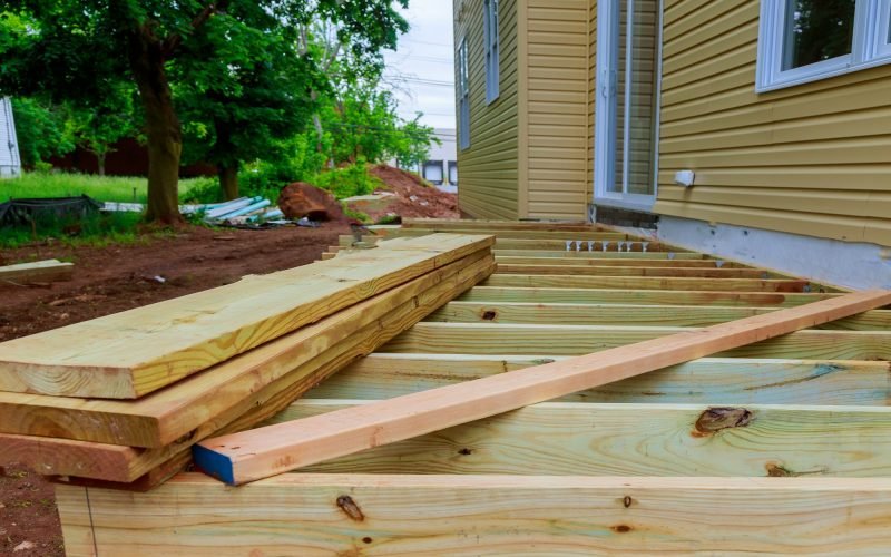 A installation wooden deck or patio new home, timber deck being constructed